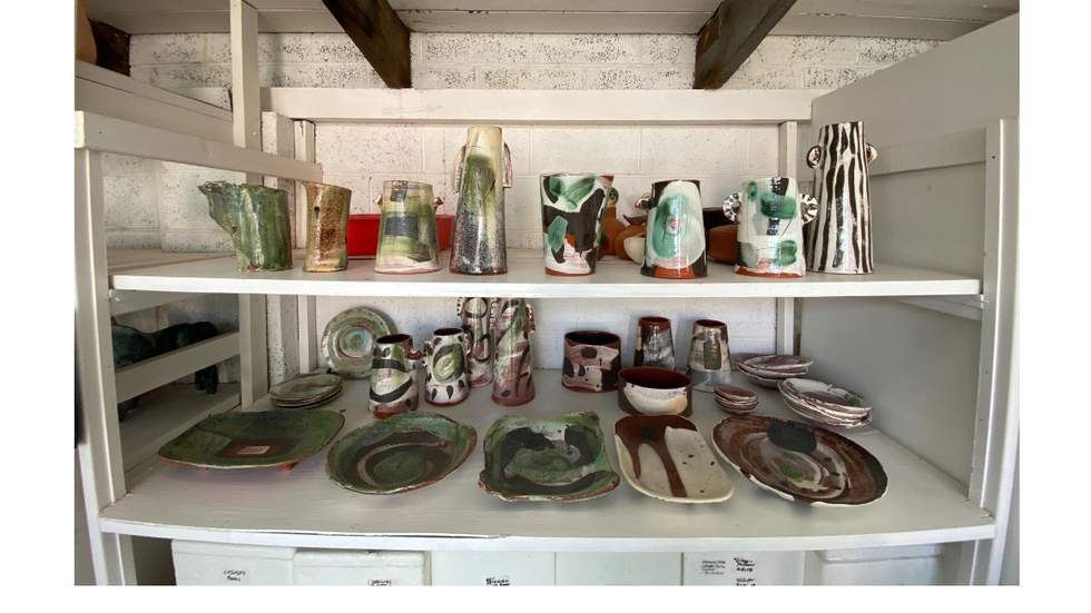 Shelves of pottery in an art studio. 