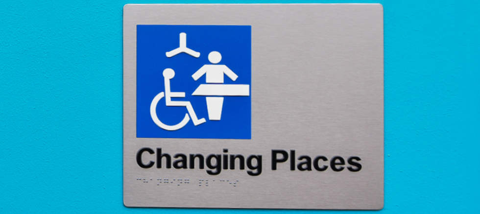 Changing Place exterior bathroom facility blue and white signage