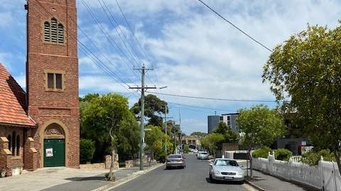 Thomas Street looking west with Church building, cars, road, footpath trees, power poles