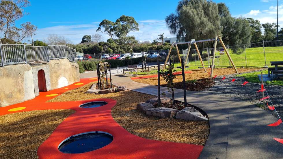 Tijljtirrin Reserve playground with inbuilt trampolines swings, trees, bridge, grass strees