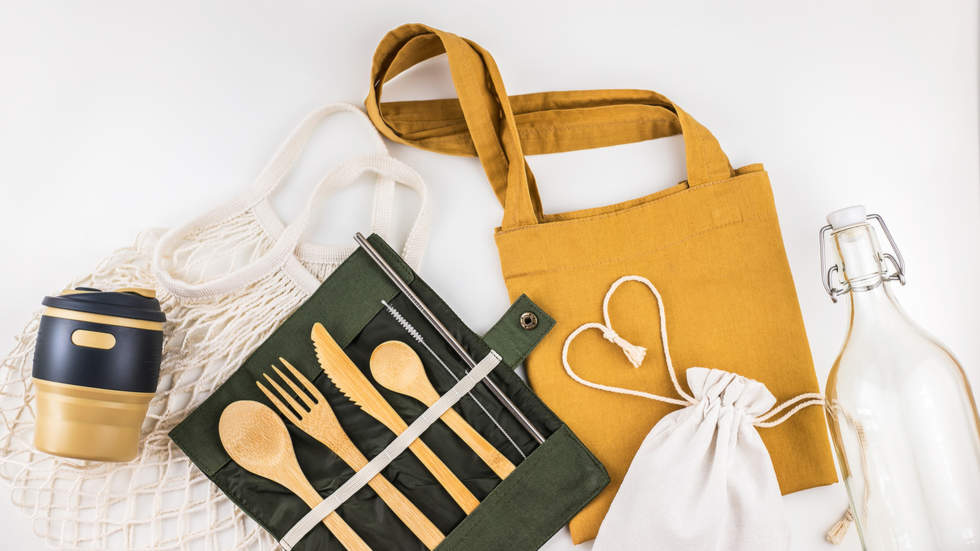 a range of reusable everyday household items including a cutlery set, a coffee cup, a bag and a bottle