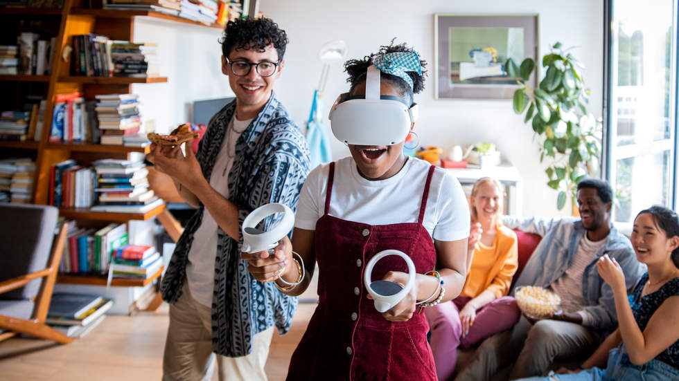 5 young people in a room one with Virtual Reality headset on Youth Services