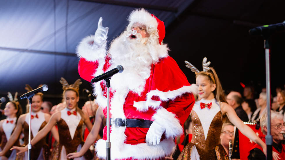 Santa with dancers dressed as reindeers