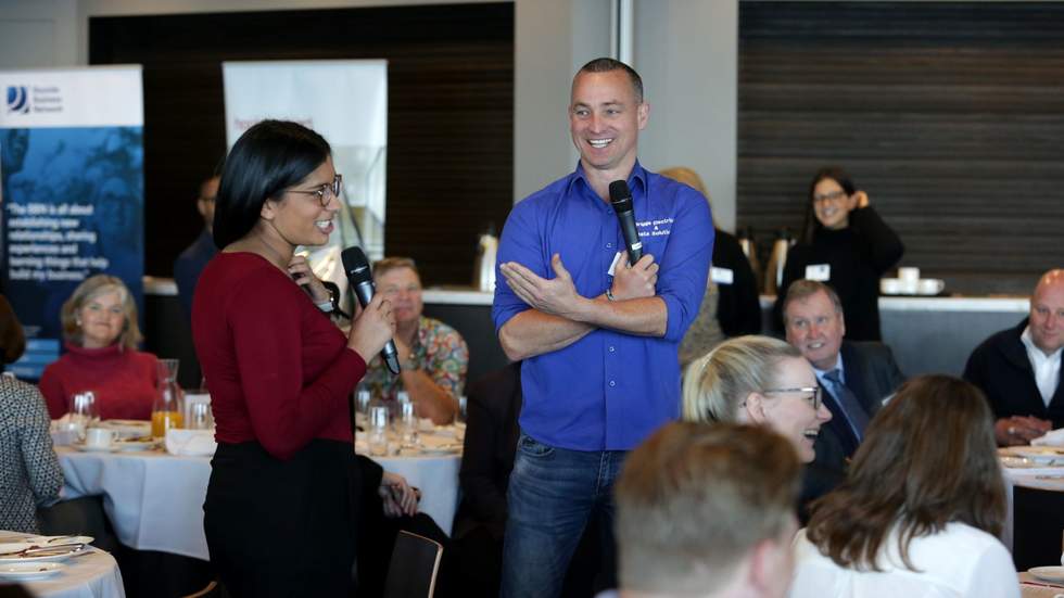 Two people with microphone at luncheon