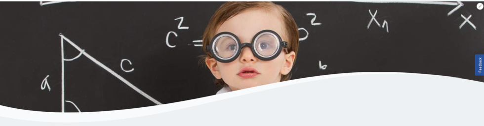 child wearing glasses in front of blackboard 