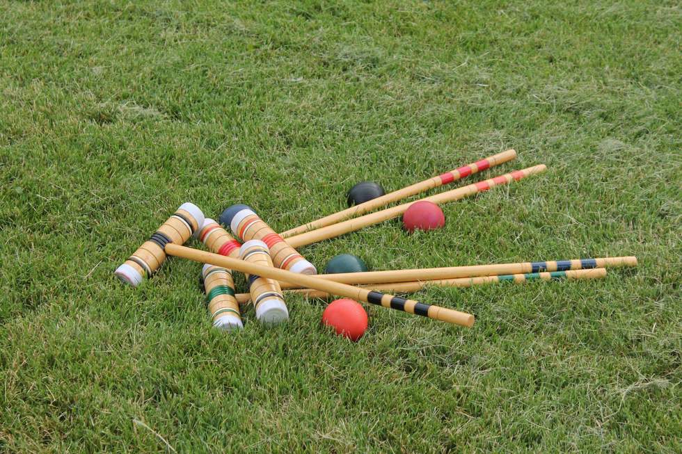 Croquet set and balls on grass. 