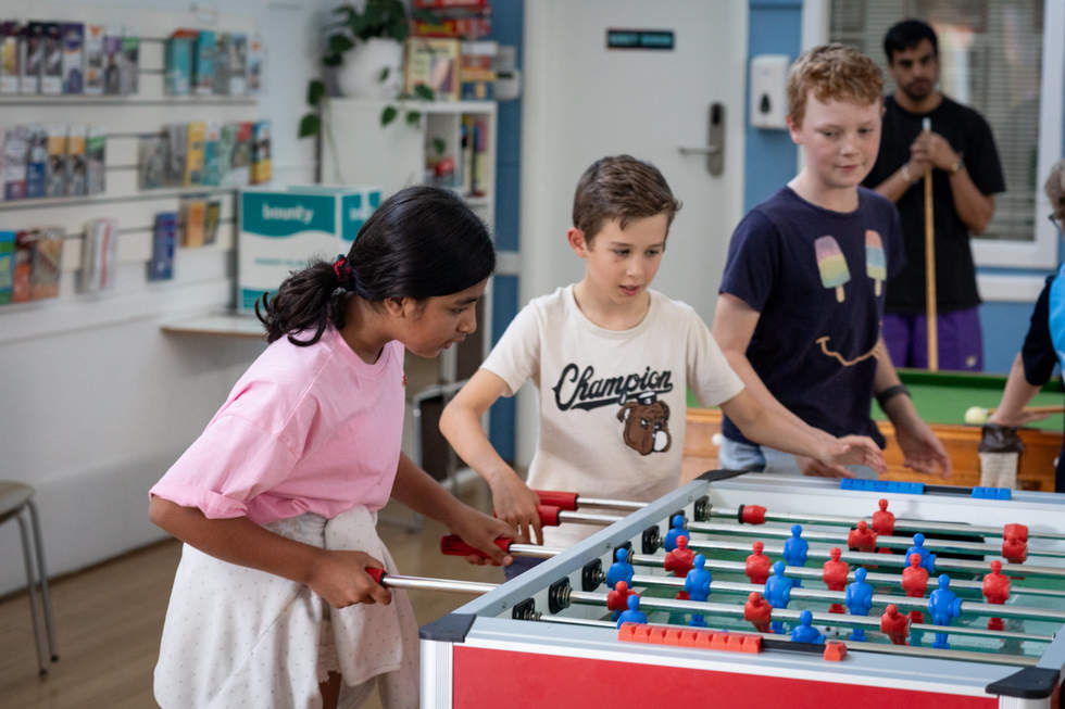 Young people playing foosball