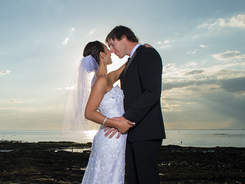 Wedding couple kissing at beach