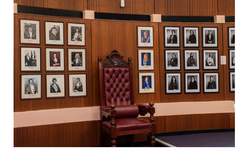 Mayoral chair with black and white former female mayors portraits installed