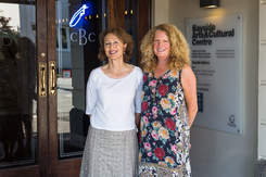 Two smiling women outside Bayside Gallery.