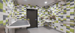 Interior view of new Changing Place facility with green grey and white tiles