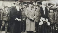 Black and white photograph of three men in a line.