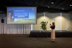 Australia Day Awards slide with woman taking photo