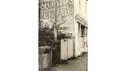 old black and white photo of spooners bread sign