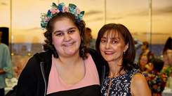 Happy girl with flowers in her hair with her mum at Aus Day Awards