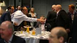 Two men shaking hands at event