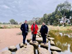 Federal Member Josh Burns MP, Federal Minister Hon Catherine King MP and Bayside Mayor, Cr Hanna El Mouallem standing on the rocks in Yalukit Willam Reserve.