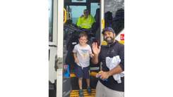 Dad and son in the bin truck with driver.