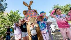 Giant bunny and kids at Easter event.