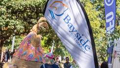 Giant bunny and Bayside Council flag at Easter event.