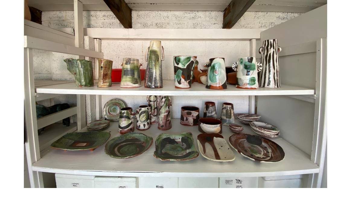 Shelves of pottery in an art studio. 