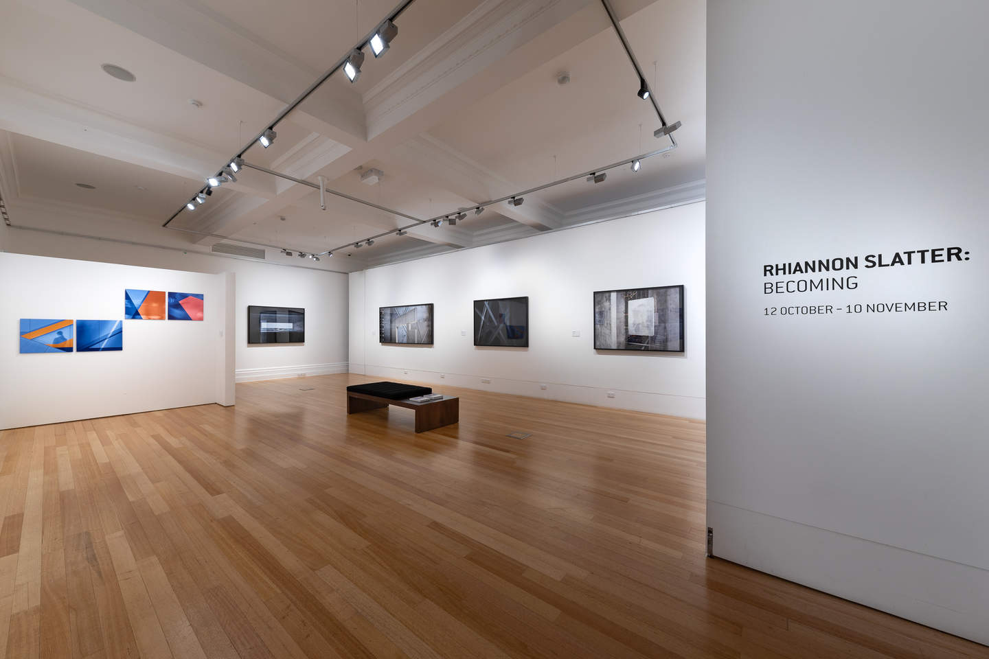 A gallery interior with large photographs on the walls.