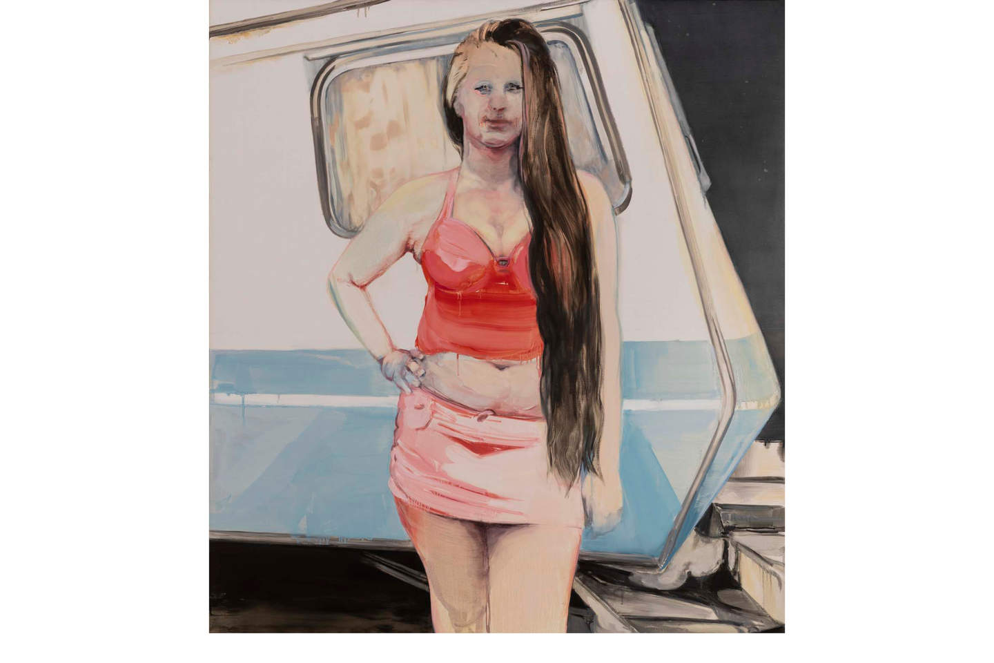 A young woman wearing a red halter neck top revealing her plump stomach poses in front of a 1970s caravan.
