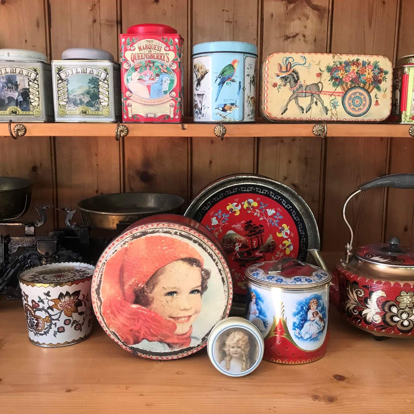 collection of colourful vintage tea and biscuit tins