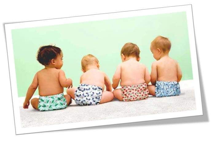 four babies lined up with their backs turned to us all wearing reusable nappies