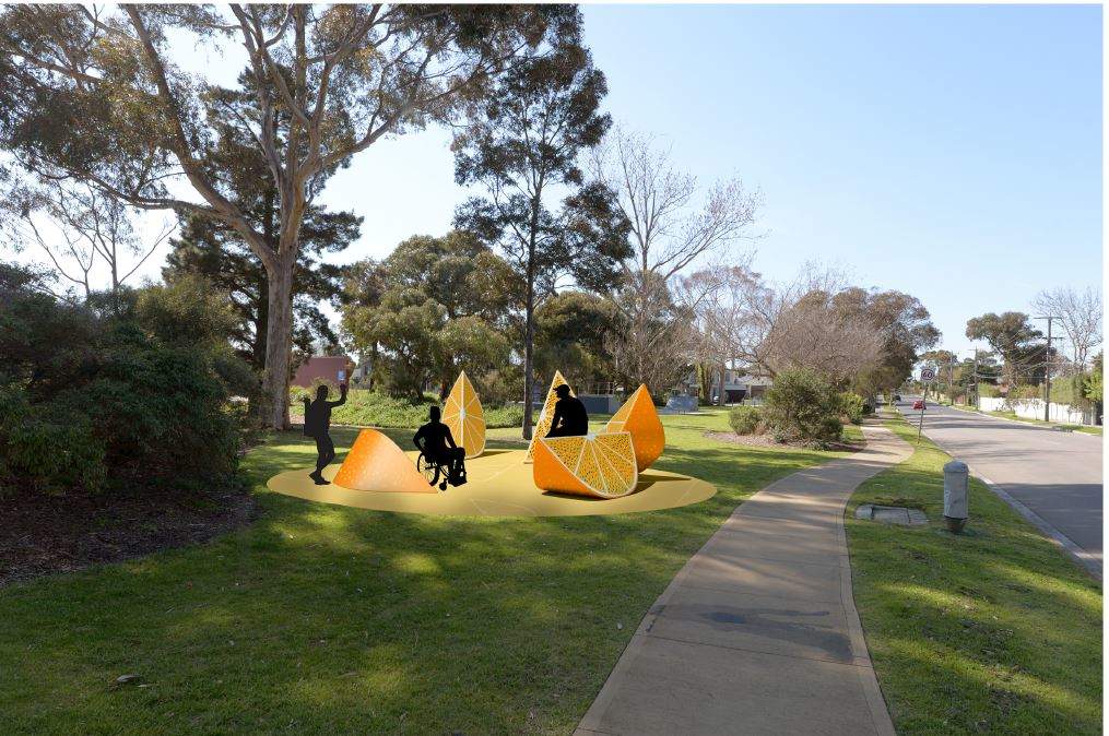 Peterson Reserve sculpture of orange quarters with people near them, footpath trees and grass