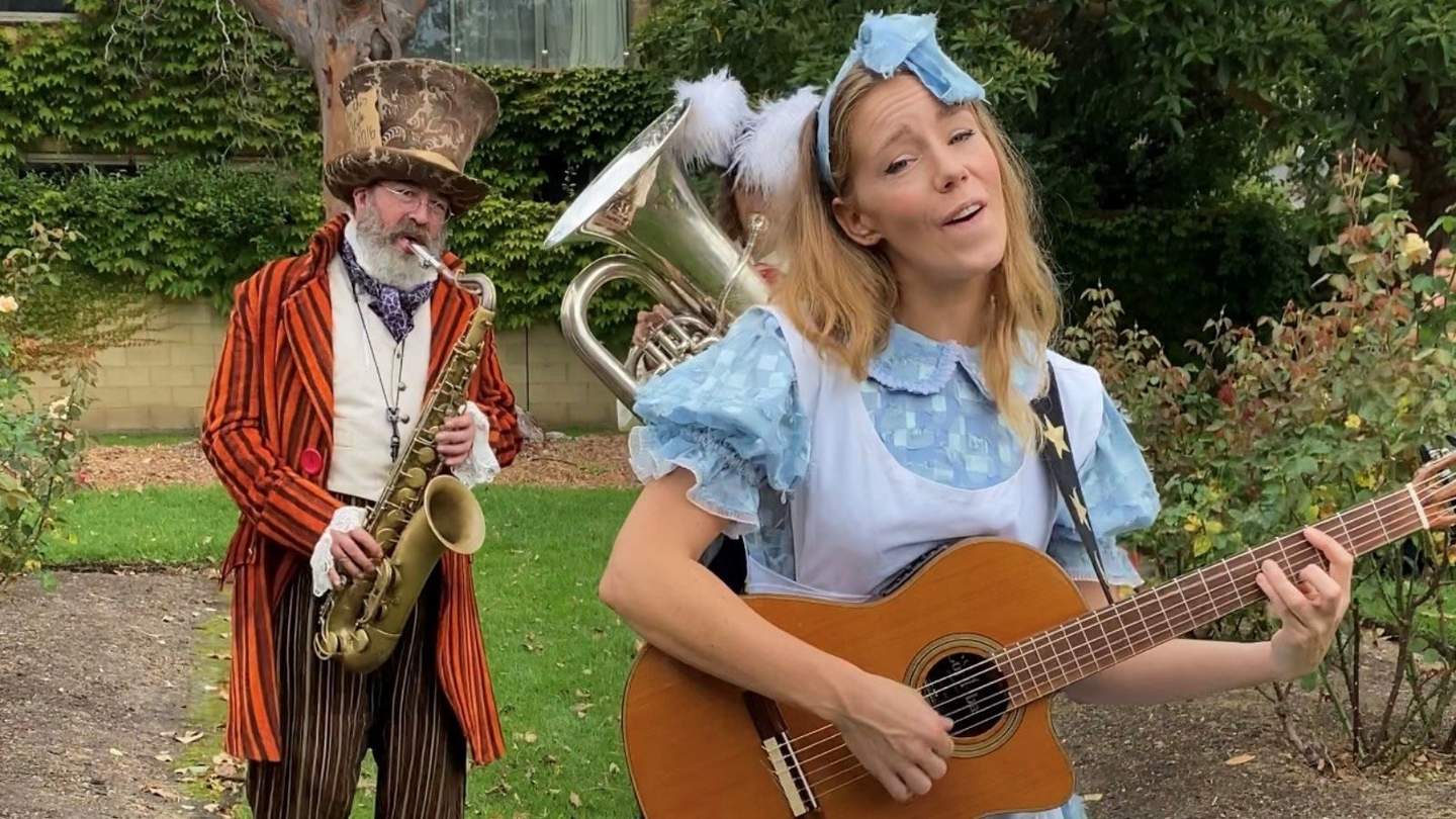 Three musicians at Billillia Garden Party dressed as characters from Alice and Wonderland