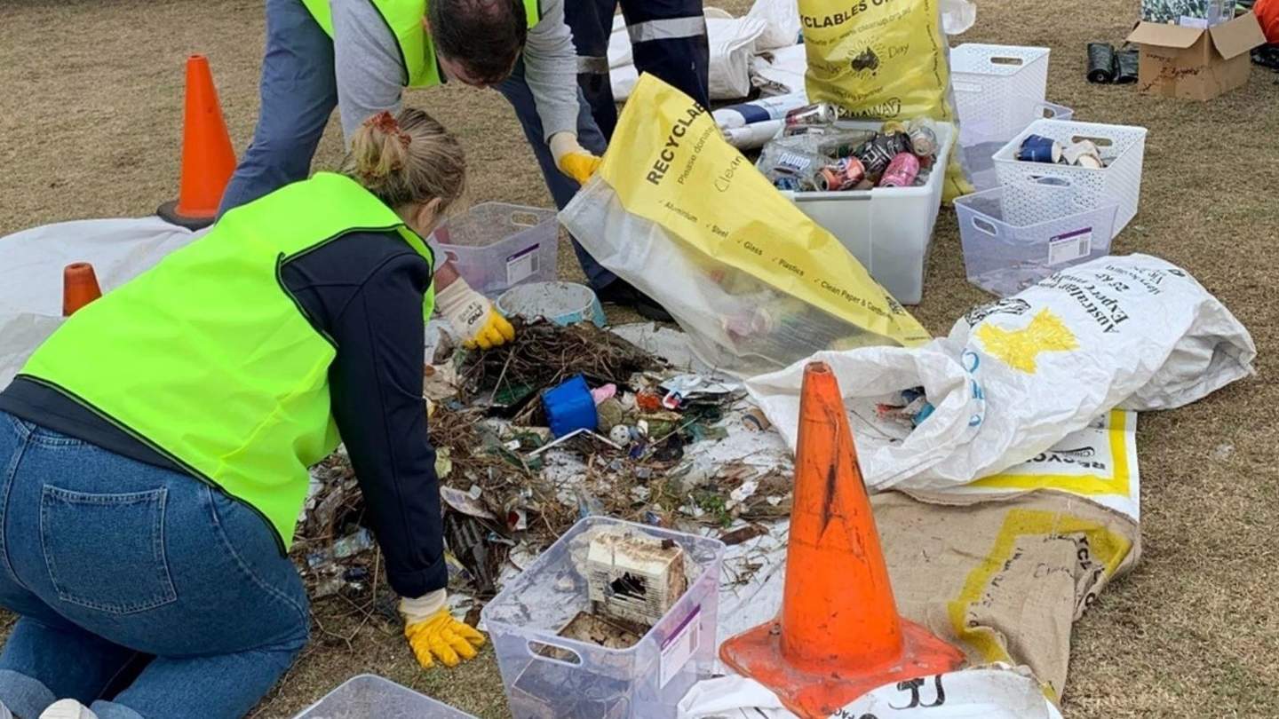 Group of people sorting through litter on Clean Up Australia Day