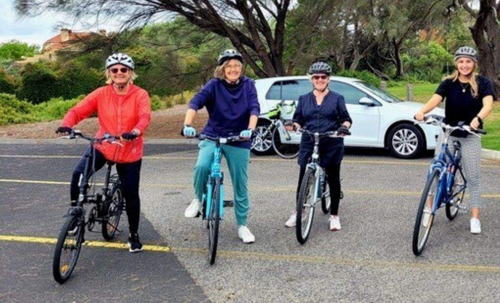 Women on bikes at cycling session in car park