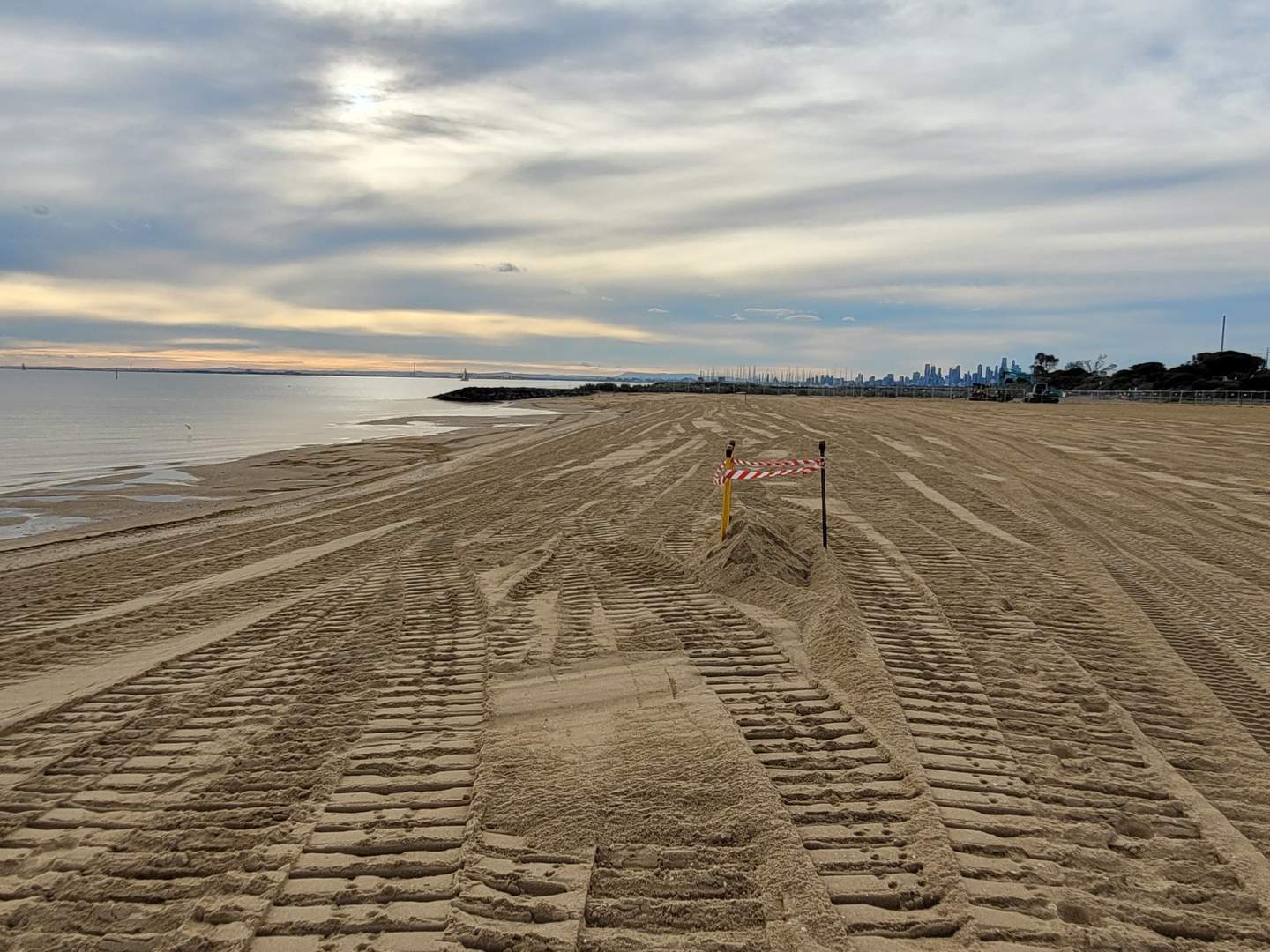 Lots of sand at Dendy Street Beach looking towards the city.