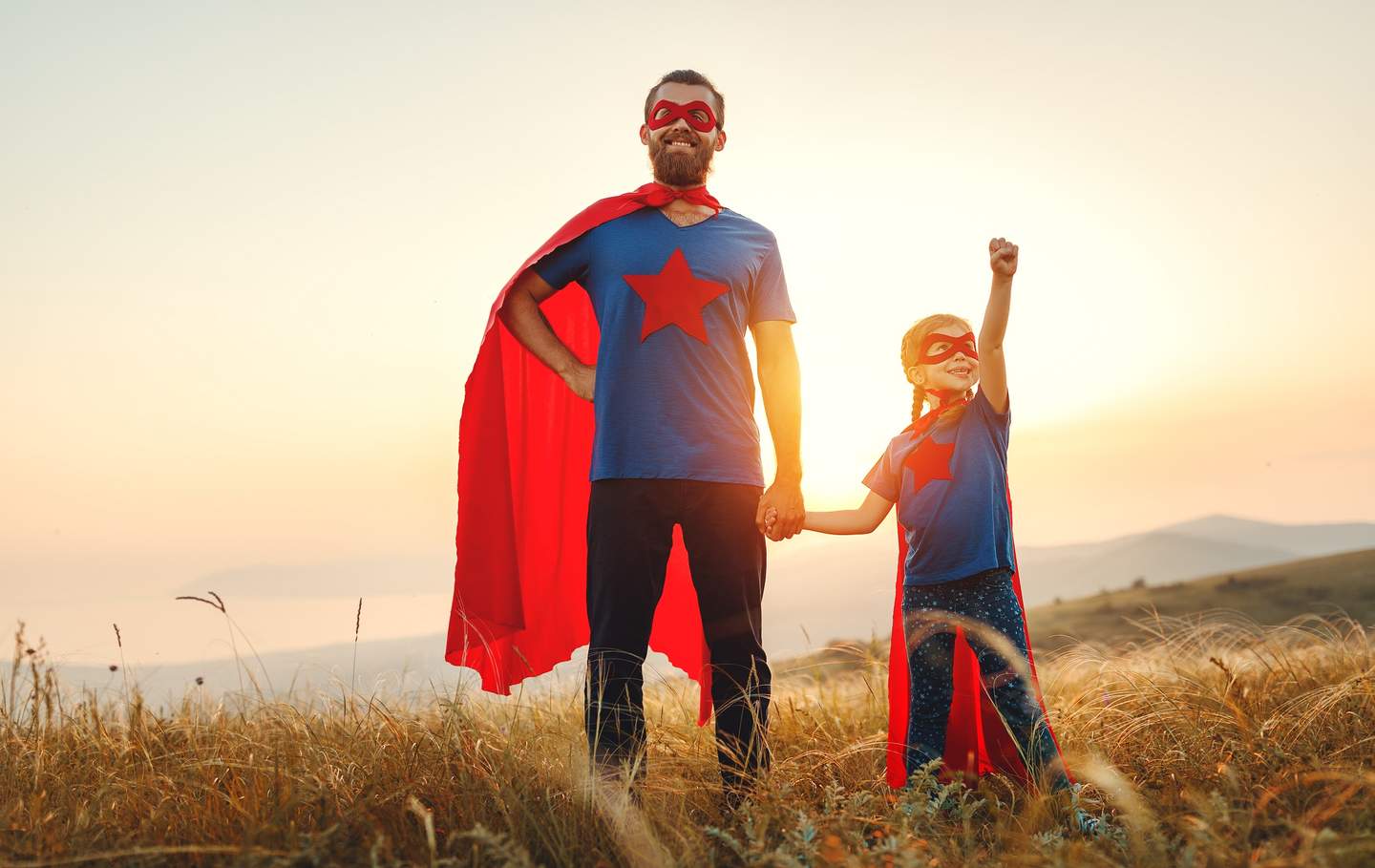 Man and girl dressed as superhero
