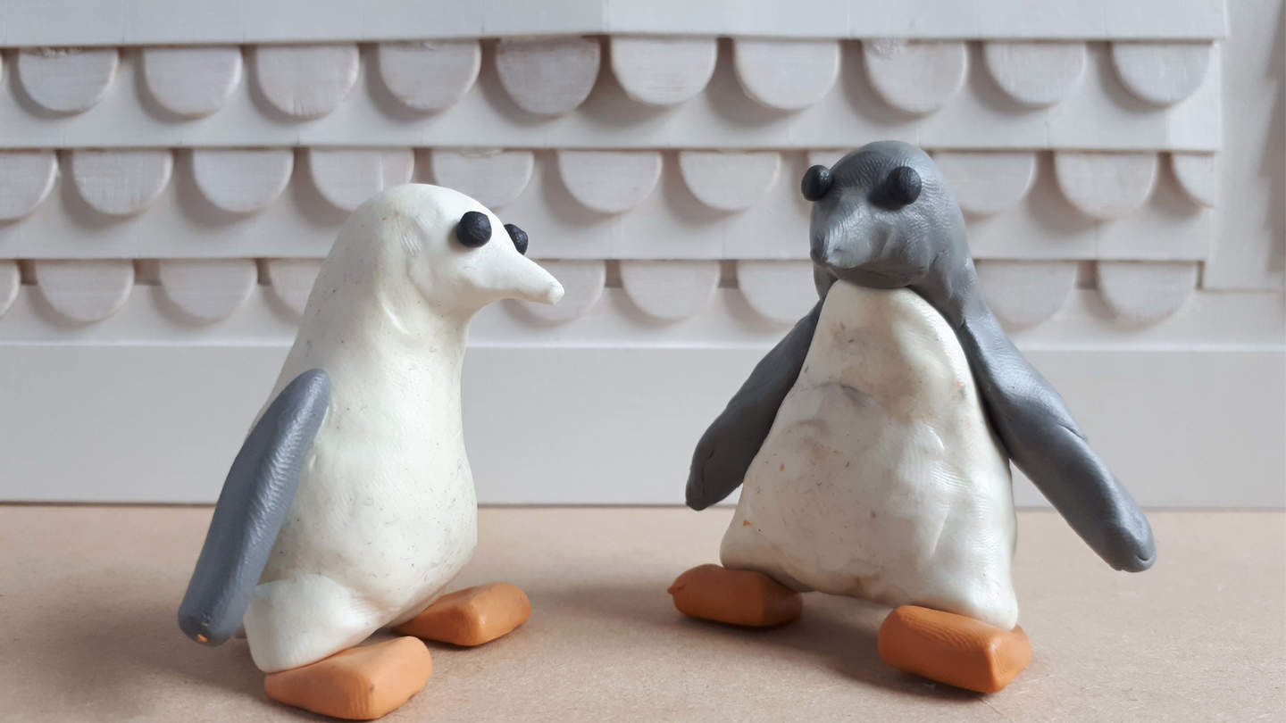 Two plasticine penguins