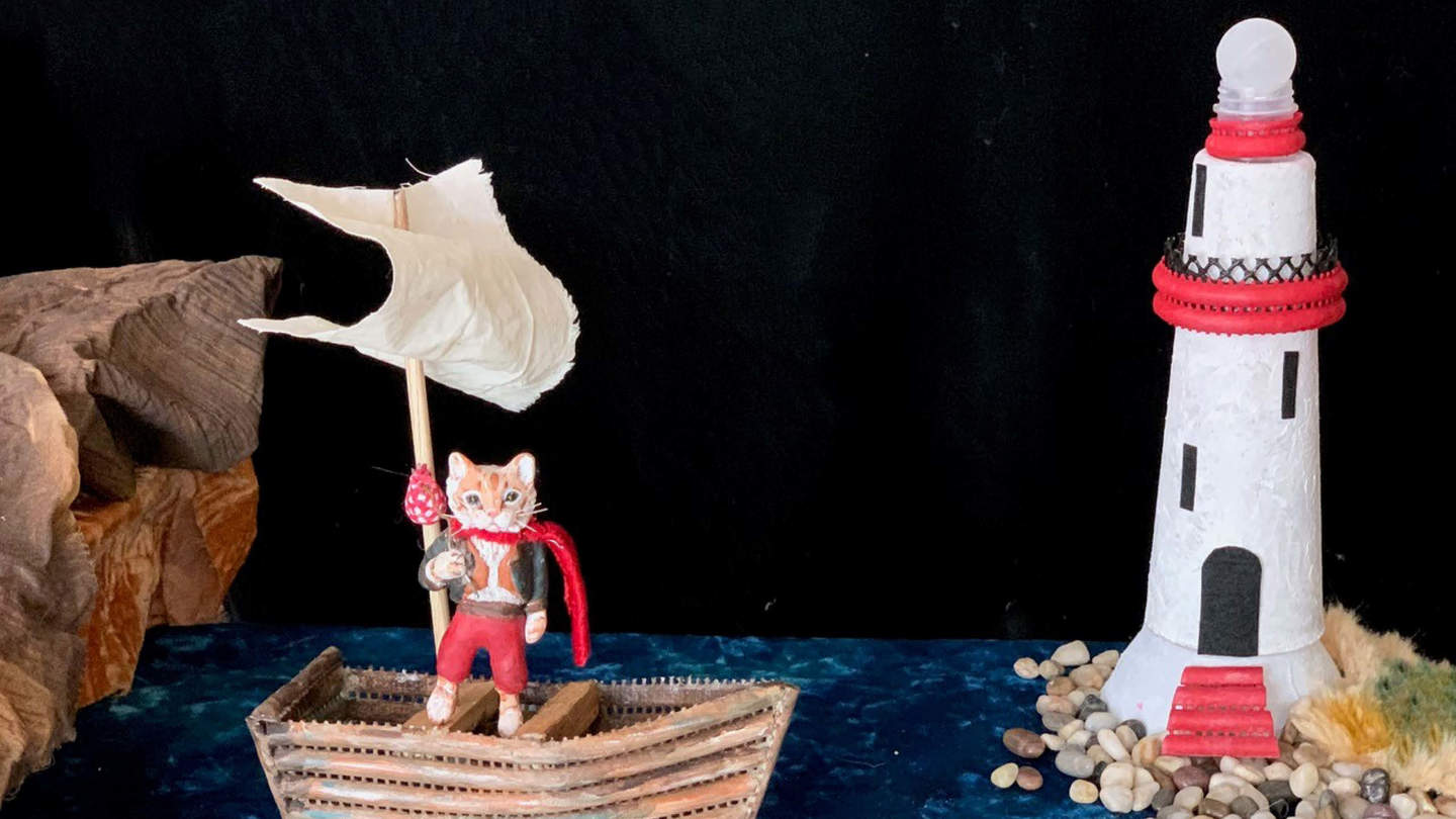 Dream puppets photo featuring a cat in boat sailing towards a lighthouse