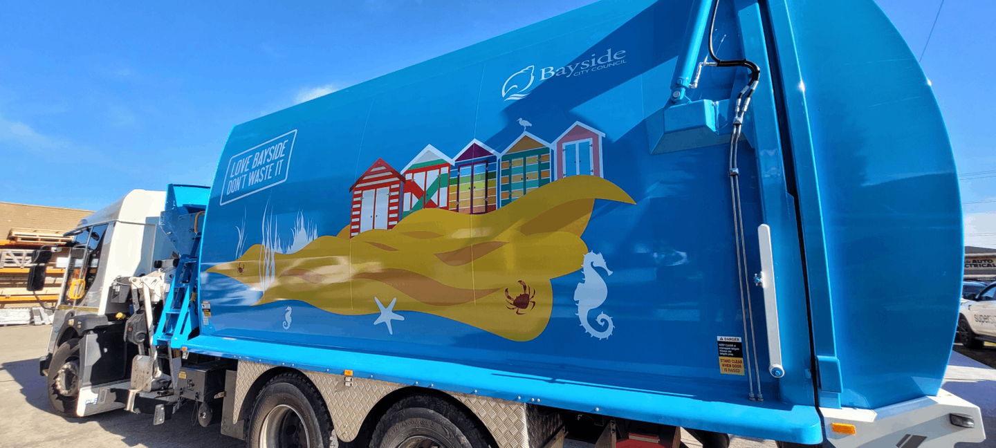 New Bayside bin collection trucks with bathing boxes and sand painted on side of truck