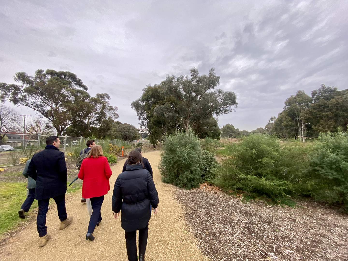 A group of people walking on the path through Yalkukit Willam Reserve
