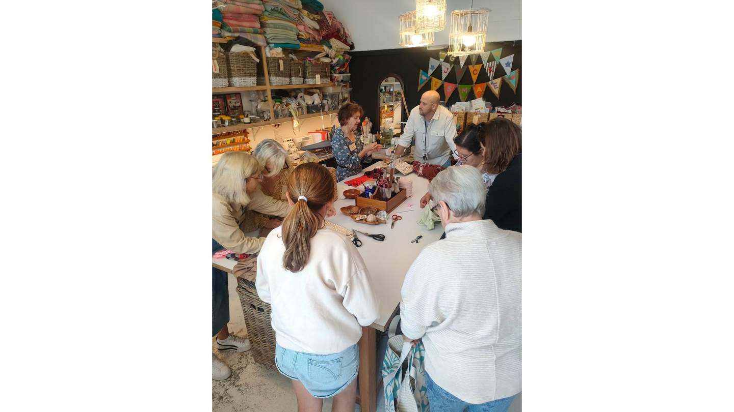Group of people at sewing workshop.