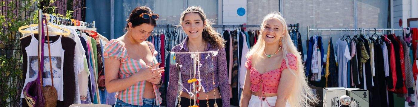 Three young girls hosting a garage sale