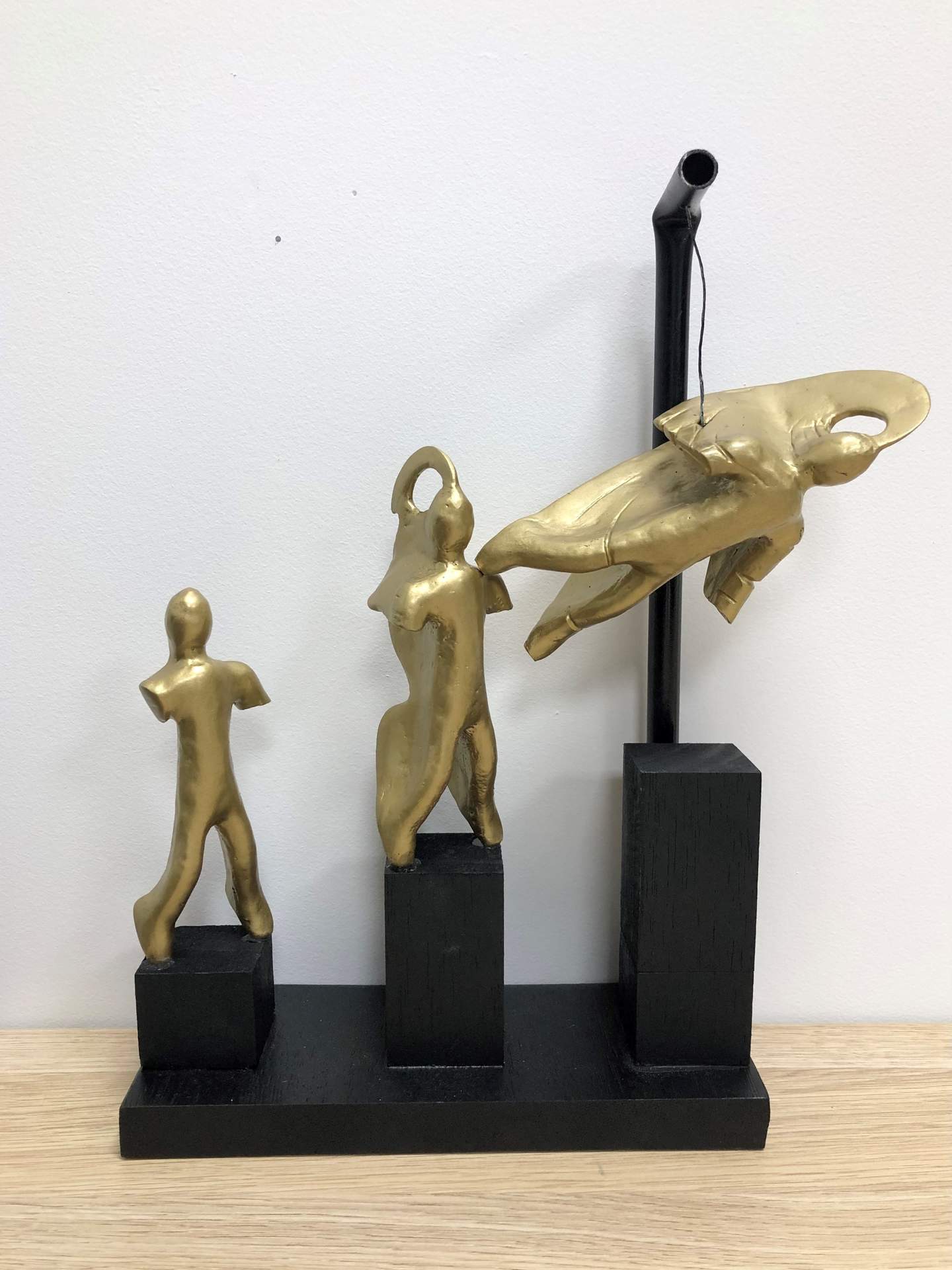 Gold and black sculpture of a persons evolution into a superhero like figure. Young People of Bayside Art Awards 2023, Maxim B 18 to 25 Runner Up. 