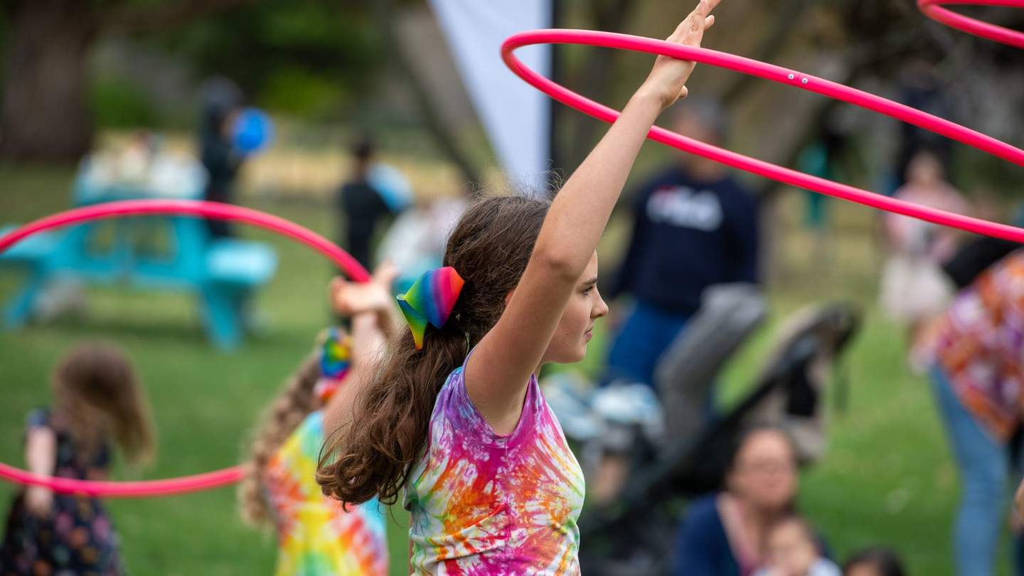 Young girl with a pink hula hoop