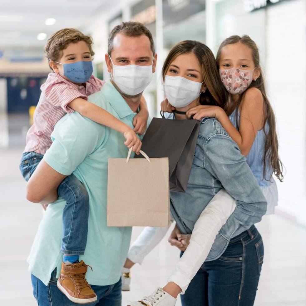 Family wearing masks in an indoor shopping centre