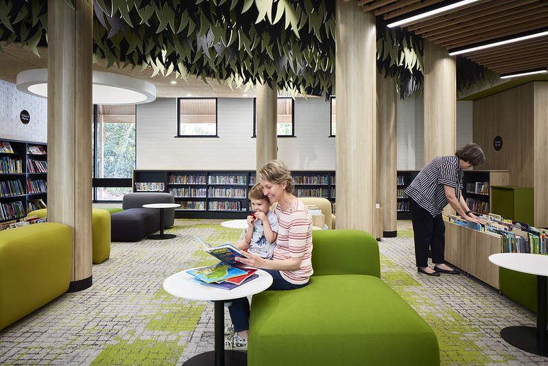 woman reads to young boy in the library