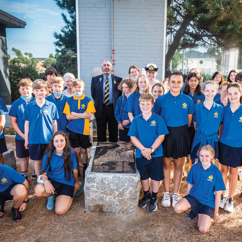 Group of school children in blue uniform in Gallipoli Memorial arden