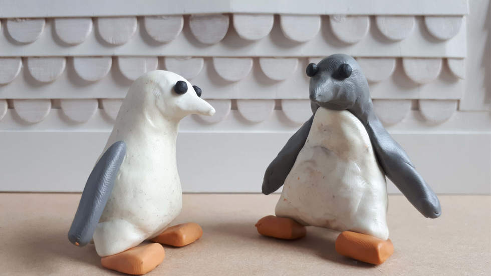 Two plasticine penguins