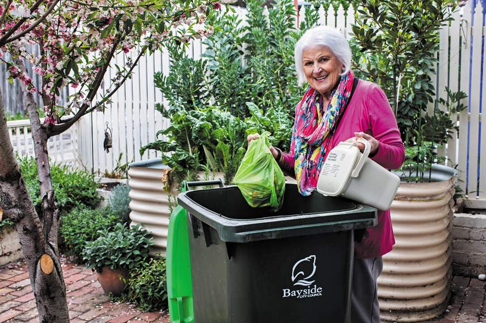 Resident placing their food scraps into their FOGO bin