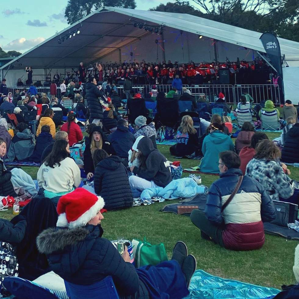 Crowd shot of Christmas carols in the park