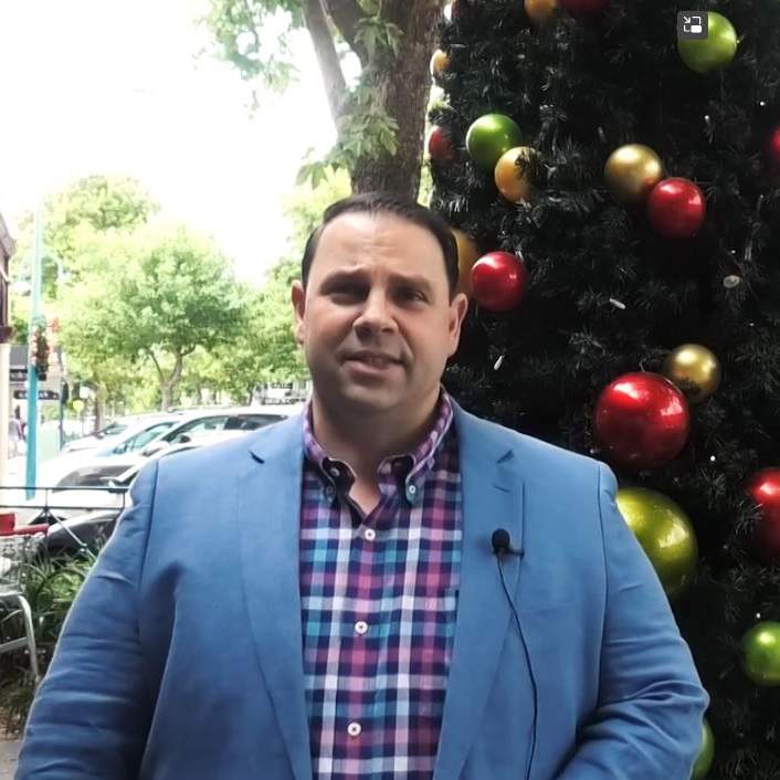 The Mayor in front of a Christmas tree